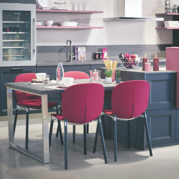 Kitchen dining table with 4 purple chairs and dinner set up